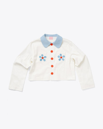 white cropped jacket with blue collar, red buttons and blue and red embroidered flowers on front pockets
