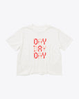 white cropped t-shirt with red and pink text graphic reading "DAY BY DAY BY DAY"