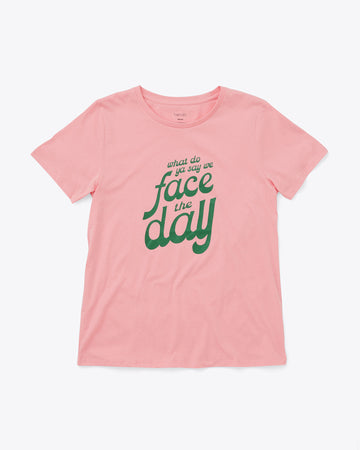pink t-shirt with green text graphic reading "what do ya say we face the day"