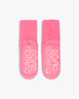 pink cozy socks with tonal "DOING NOTHING" text on sole
