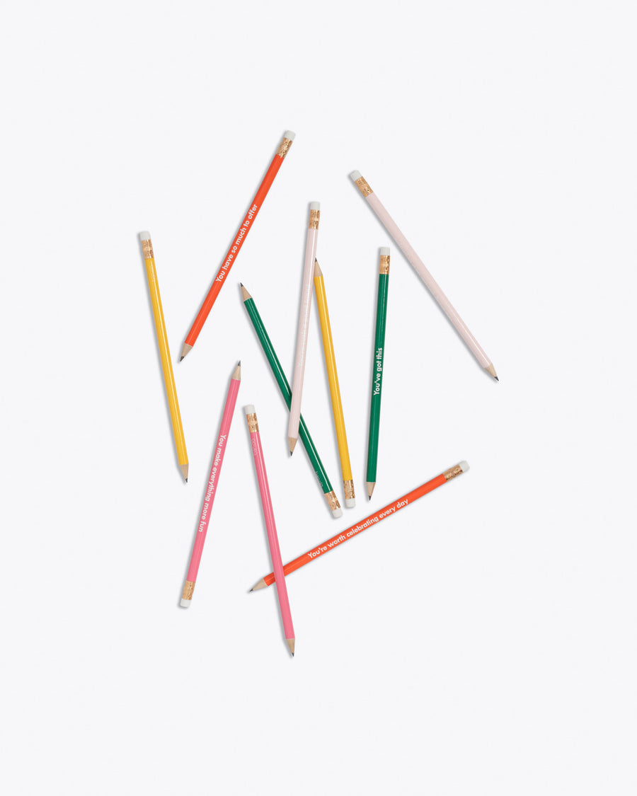 scattered  set of 10 pencils in pink, red, blush, green, yellow with compliment phrases in white text