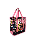sideview of reusable market bag with black ground, pink trim/straps, and all over multicolor abstract floral print