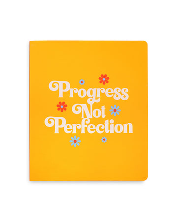 yellow undated planner with 'progress not perfection' across the front