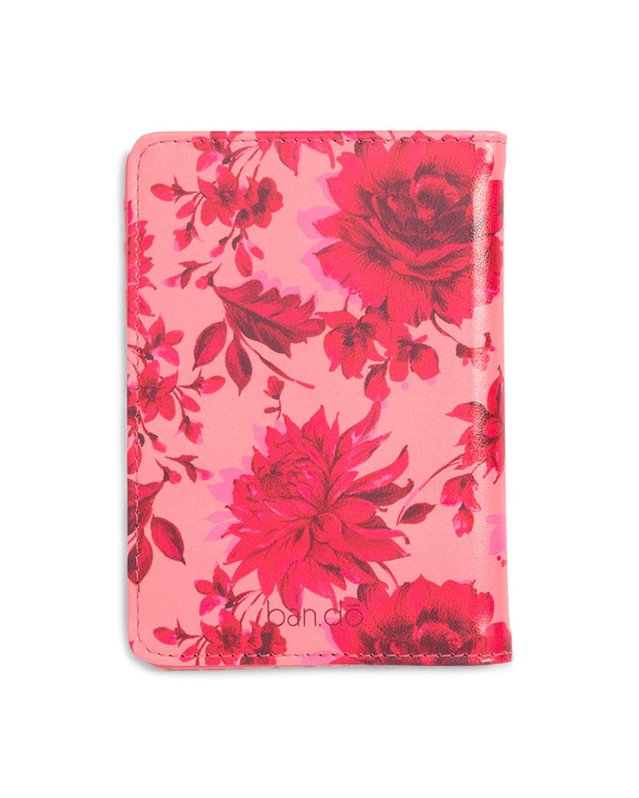 Back shot of a leatherette passport holder in a pink floral motif.