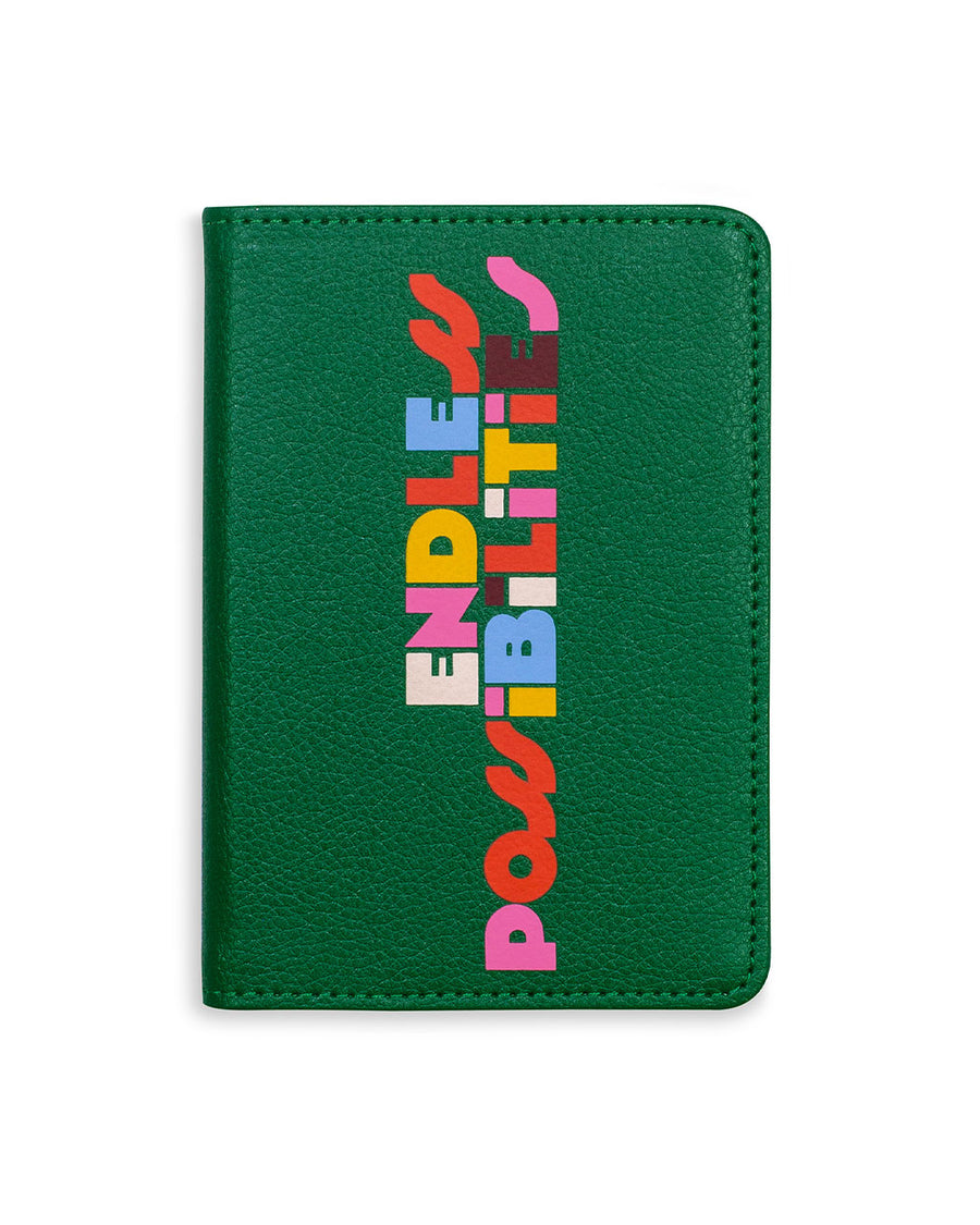 dark green passport wallet with multicolor 'endless possibilities' text on the front