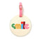 round luggage tag with cream ground, multicolor 'smile' and pink closure 