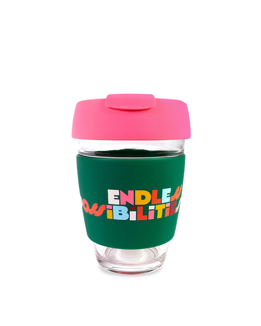 12 oz. dark green and hot pink glass travel mug with multicolor words 'endless possibilities'