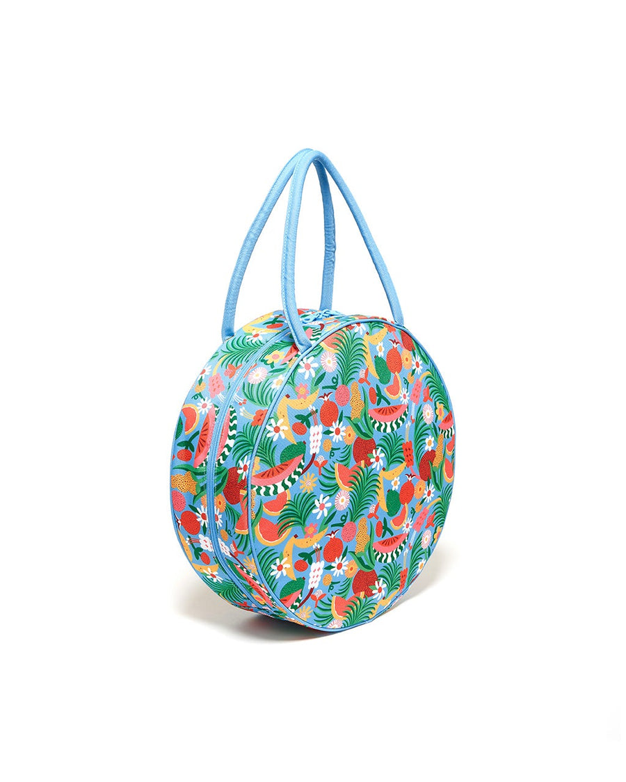 side view circle bag with blue ground and all over abstract fruit print