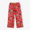 long pajama pants in red and pink bold floral pattern and yellow tie waist and piping detail at the ankle