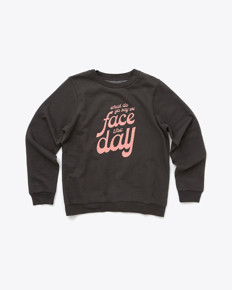 black sweatshirt with 'what we do ya say we face the day' in pink lettering