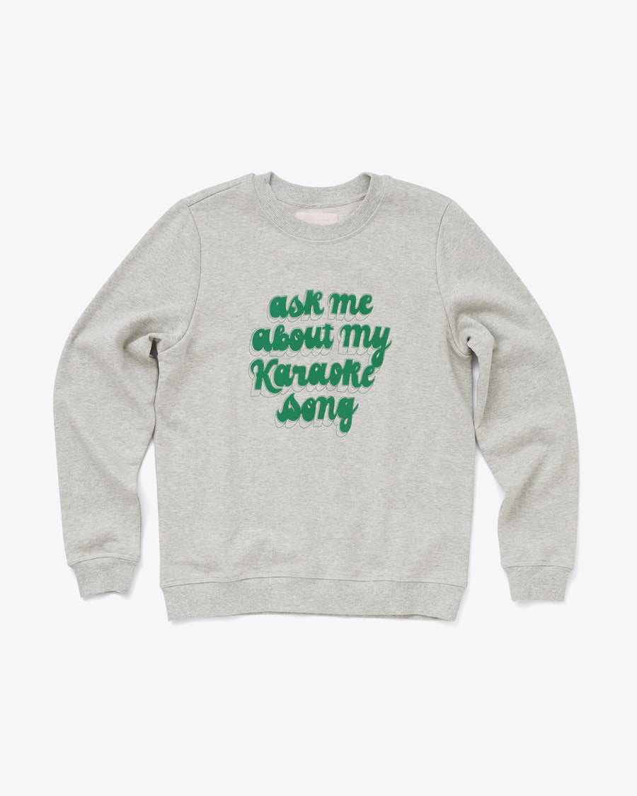 grey balloon sleeve sweatshirt with the words ask me about my karaoke song in green letters