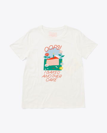 ivory t-shirt with whimsical cake illustration and "OOPS! I BAKED ANOTHER CAKE" text graphic in red