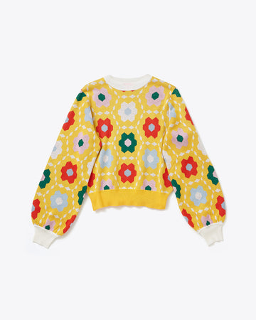yellow sweater with multicolor quilt print