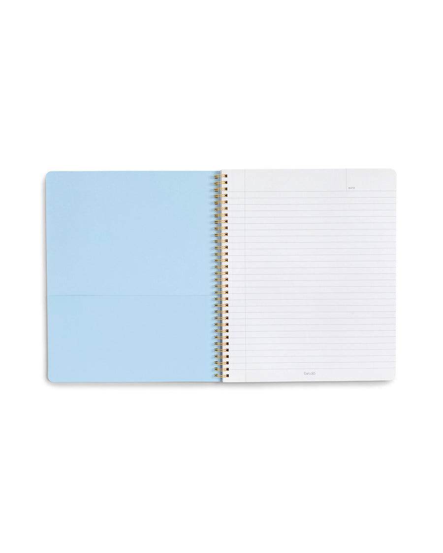 inside front cover of spiral bound notebook with blue pocket and lined page