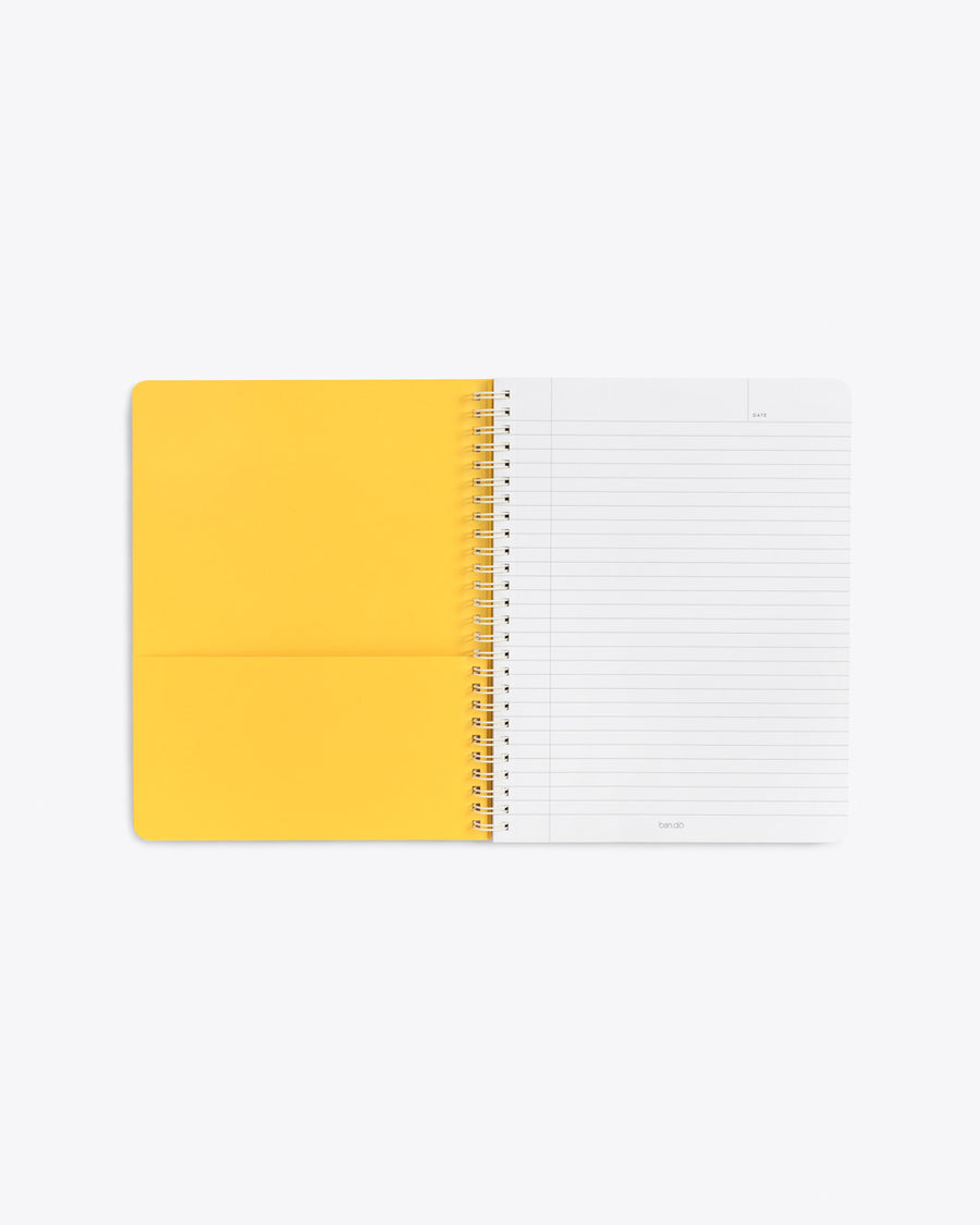 interior image of notebook showing lined pages and yellow end sheet with a pocket