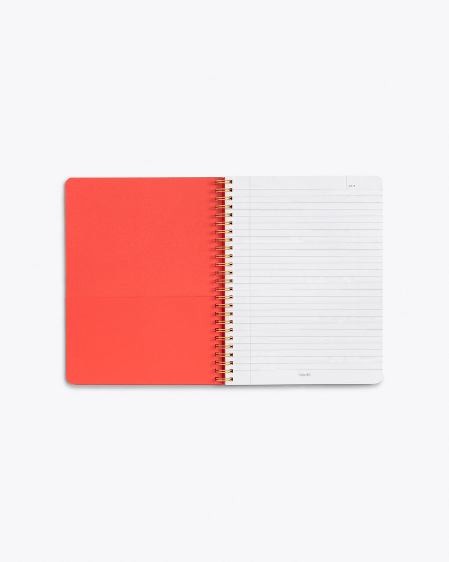 inside front cover of spiral bound notebook with red pocket and lined page
