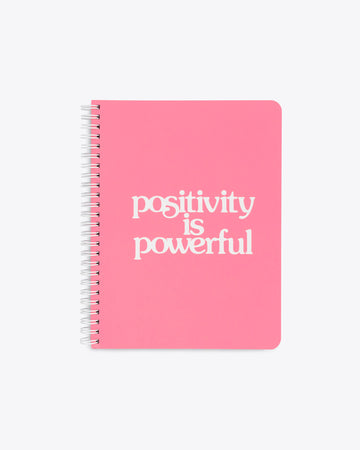 bright pink notebook with the words positivity is powerful on the cover