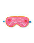 pink eye mask with "ENJOY THE LITTLE THINGS" text graphic and blue band