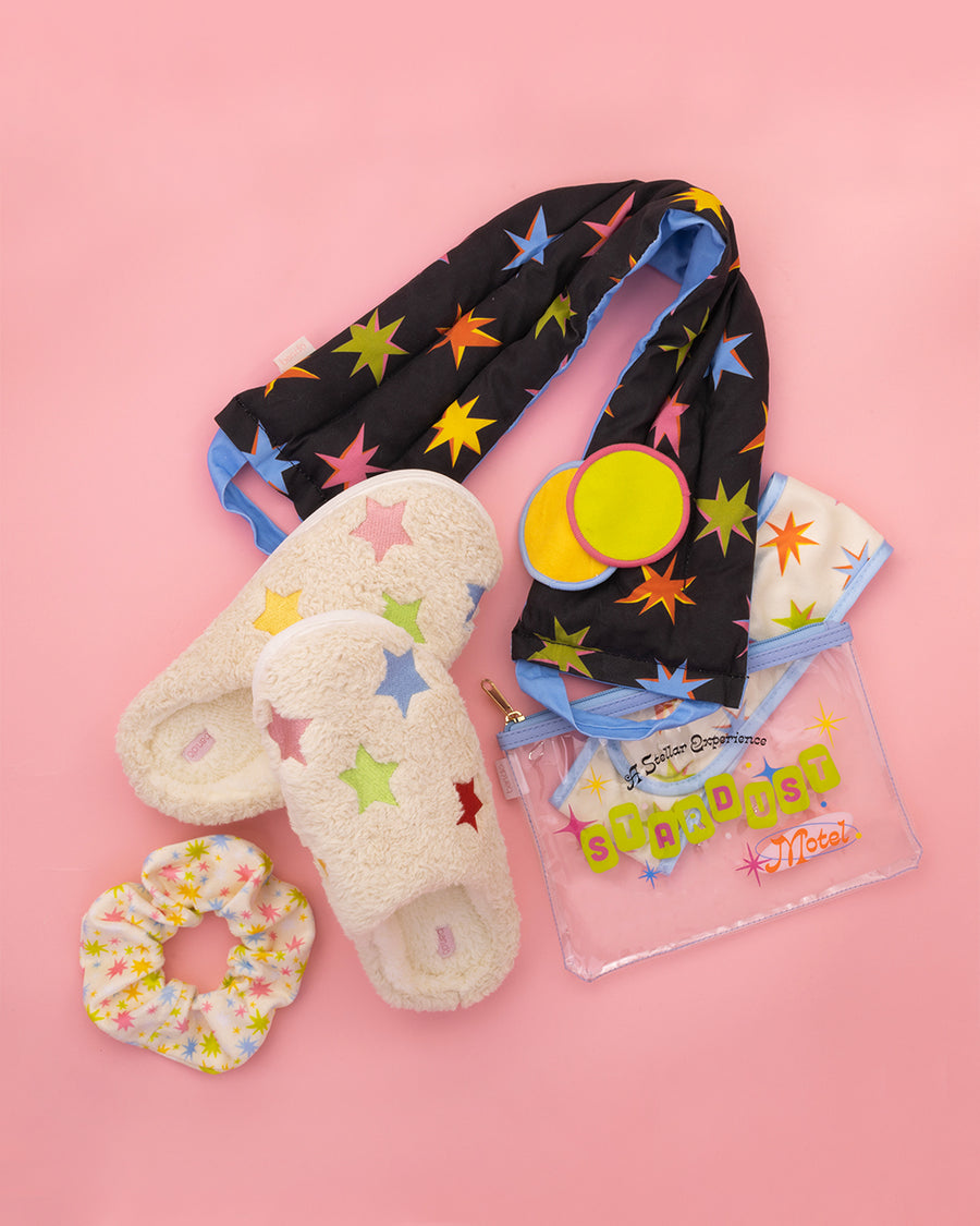 editorial image of starburst neck wrap, slippers, and spa set