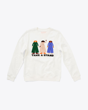 ivory sweatshirt with illustration of 3 women standing side by side with "TAKE A STAND" text graphic