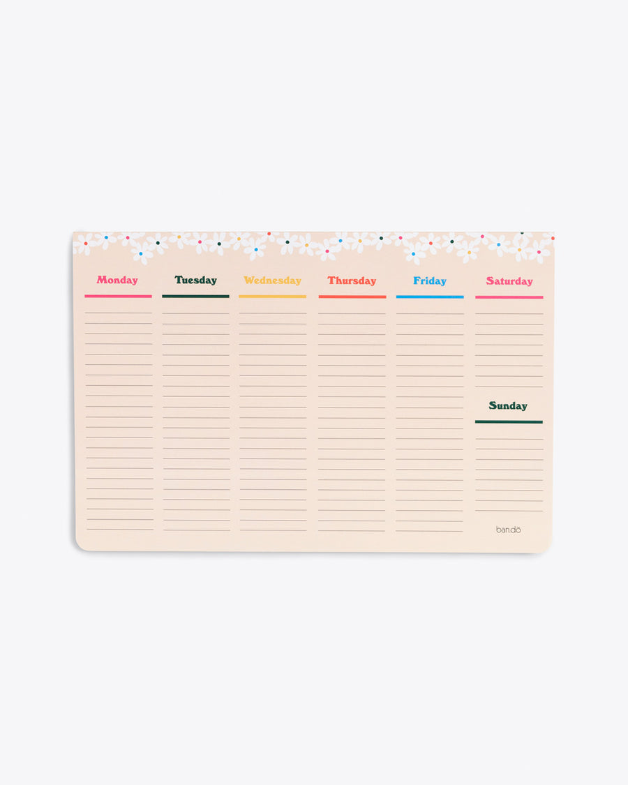 large week to week desk notepad with a daisy trim at the top, a section for every day of the week