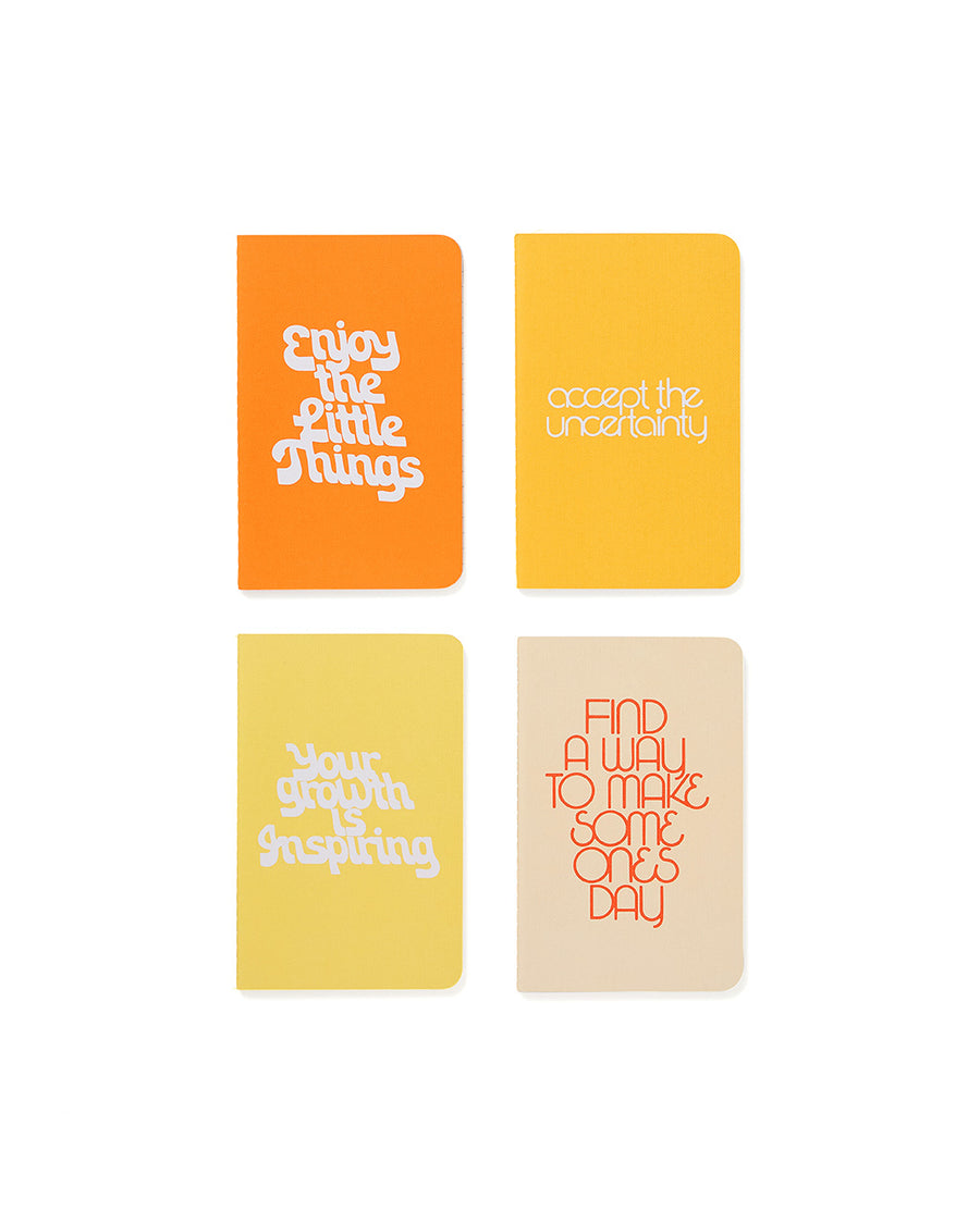 notebooks that say: 'enjoy the little things', 'accept the uncertainty', 'your growth is inspiring', 'find a way to make someones day'