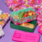 editorial image of bento lunch box with reusable utensils and filled with lunch food.
