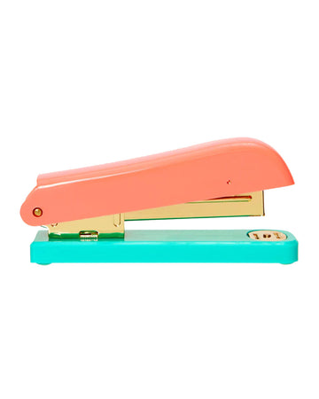 orange and teal stapler with gold accents